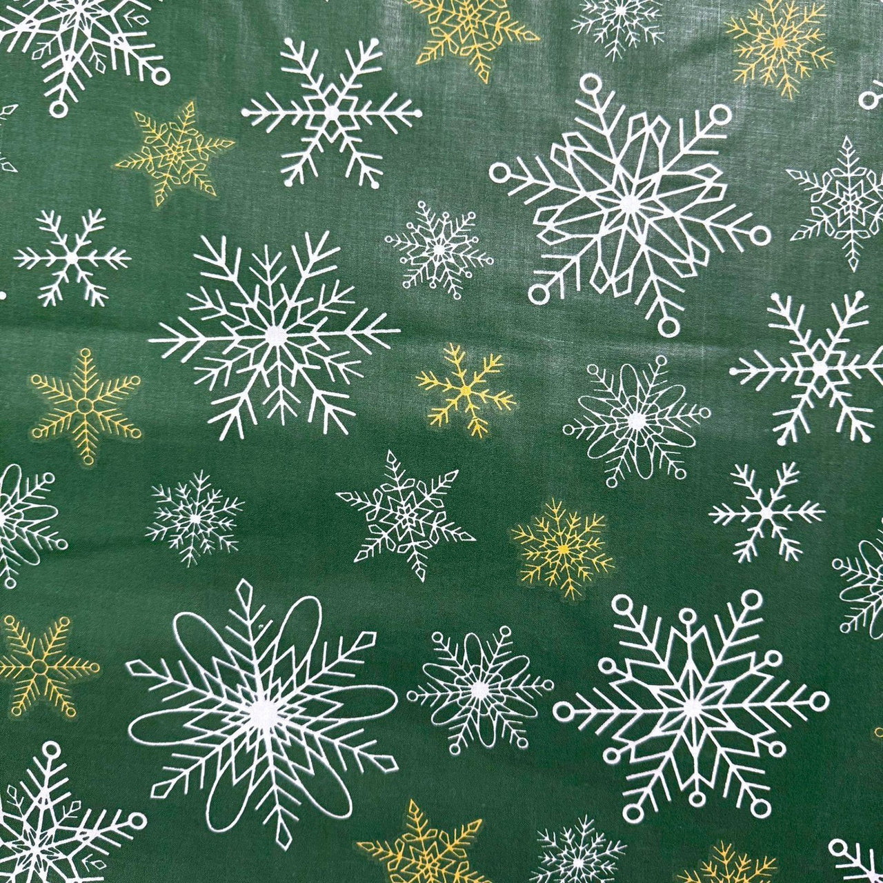 Cotton Fabric - White and gold snowflakes on green background